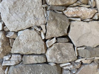 Taş duvar fotoğrafı, dokulu arka plan. Kırsal taştan bir duvara yakın çekim.