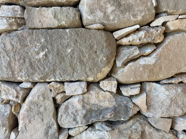 Taş duvar fotoğrafı, dokulu arka plan. Kırsal taştan bir duvara yakın çekim.