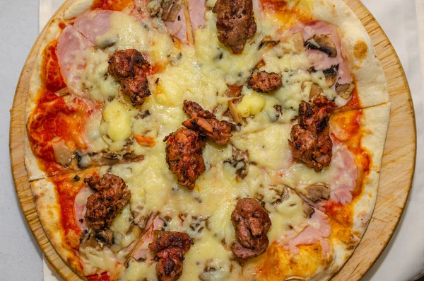 Pizza with meat and cheese