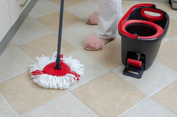 Mop, bucket and woman's feet — Stock Photo, Image