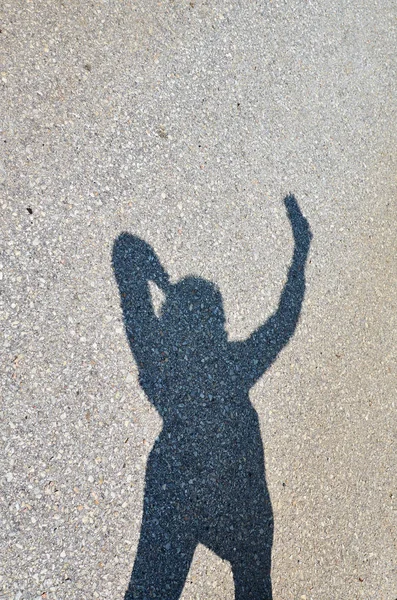 Woman s shadow posing to take selfie