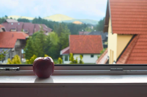Red roofs and red apple — Stock Photo, Image