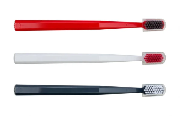 Novas Escovas Dentes Com Tampas Plásticas Transparentes Preto Vermelho Branco — Fotografia de Stock