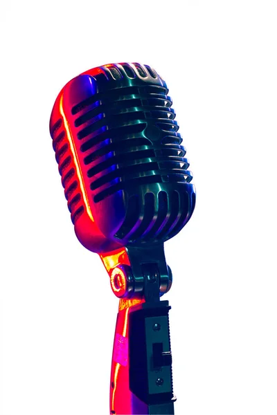 Vintage microphone, lit by blue and red light. isolated on white background