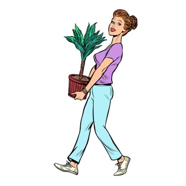 bir kadın saksı bitkisi ile bir çömlek taşır