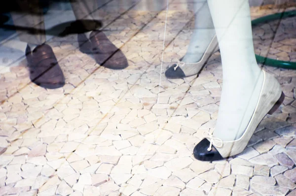 Mannequin man and woman shoes on stone floor. No people