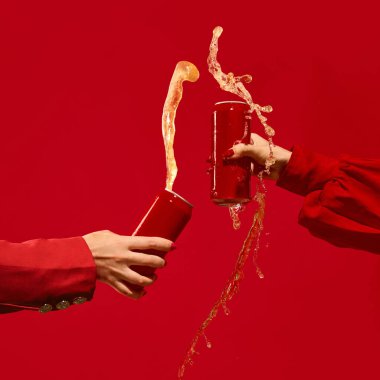 İki kırmızı kutu enerji dolu canlı kırmızı arka planda bira sıçramasıyla çarpışıyor. İçecek markası kavramı, editoryal görseller, monokromatik kampanyalar ve gençlik pazarlama. Metin ve reklam için maket