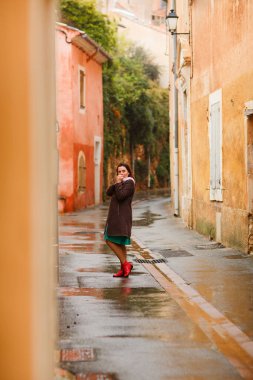 Kız Provence France 'ın küçük bir kasabasında yağmur altında yürüyor. Avrupa seyahati.