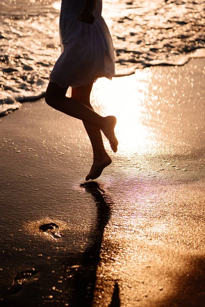 little feet leave footprints on sandy shore of sea. walks on beach.