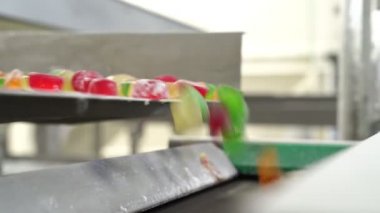 Renkli marmelat taşıyıcıya düşüyor. Üretim hattı. Şekerleme fabrikası..