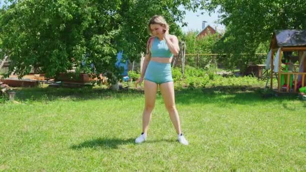 Exercices de squat. fille fait du sport dans le jardin. forme physique après l'accouchement — Video