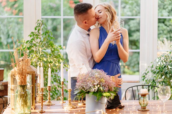 Casal definir mesa para jantar romântico, beijando e abraçando . — Fotografia de Stock