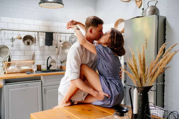 Пара обнимается дома на кухне. молодожены в медовый месяц. — стоковое фото