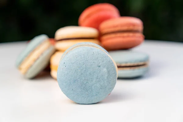 Multicolored macarons from natural ingredients and colors on white table. — Stock Photo, Image