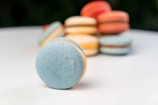 Multicolored macarons from natural ingredients and colors on white table. — Stock Photo, Image