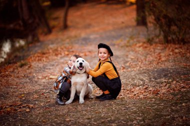 Sonbahar Parkı 'nda Golden Retriever' da yürüyen kızlar.