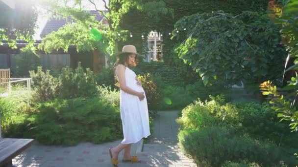 Mutlu çiftin günbatımında, bahçede bebek bekliyorlar.. — Stok video