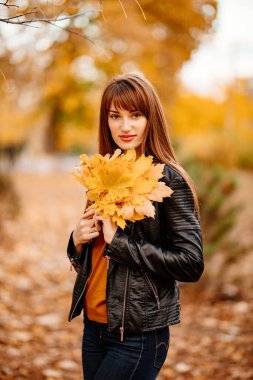 Sarı akçaağaç yapraklı güzel bir kadın.