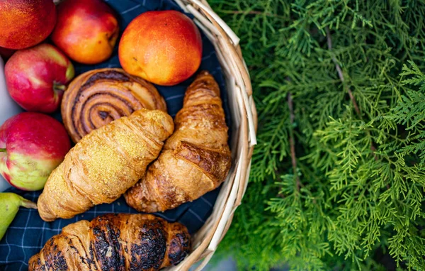 Meyve ve çöreklerle dolu bir sepet manzarası. 