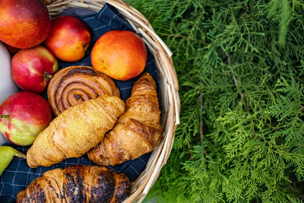 Meyve ve çöreklerle dolu bir sepet manzarası. 