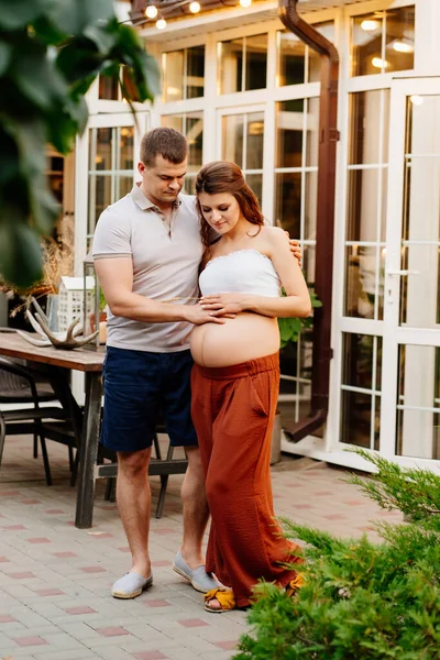 Serata romantica in giardino di coppia in attesa di bambino — Foto Stock