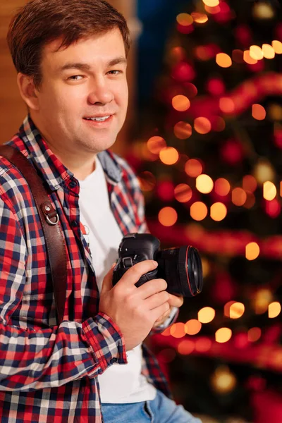 photographer in plaid shirt in xmas decorations