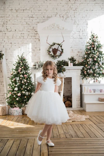 Girl on background of Christmas trees in loft. — Stock Photo, Image