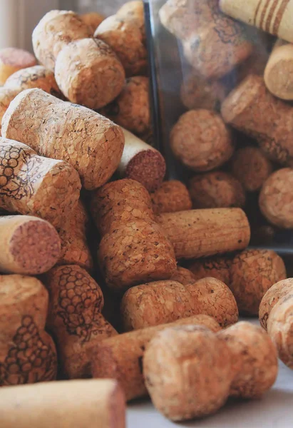a bunch of wine corks and a glass jar