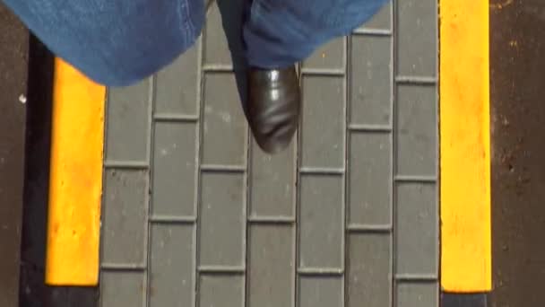 Man Walks Paving Tile Curb Stones Black Yellow Legs Denim — Stock Video