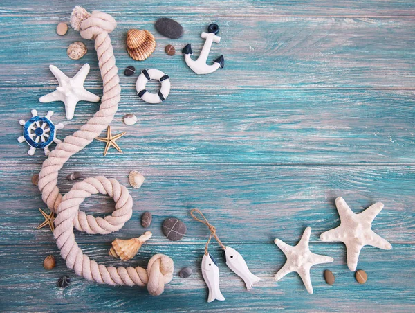 Seashells and sea decorations with rope on a  wooden background