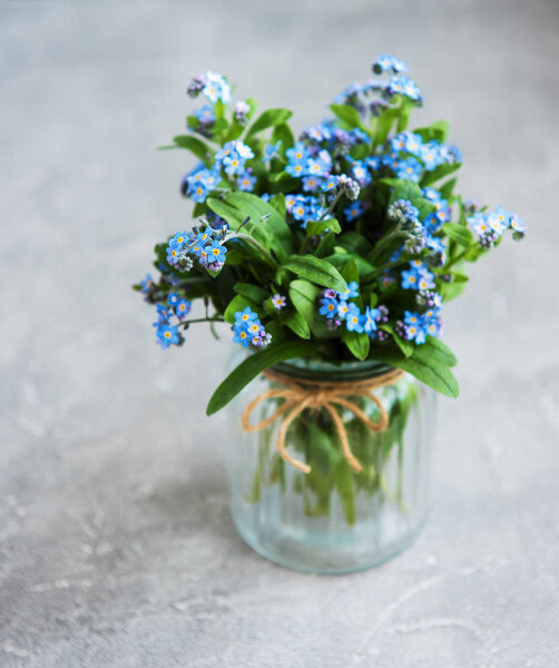 bouquet of forget me nots in glass  vase