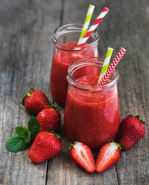 Kavanoz ile ahşap bir masa üzerinde çilek güler yüzlü