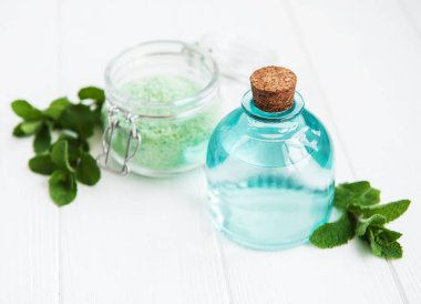 temel aroma yağı ile masaj tuz ve nane bir beyaz tahta masada