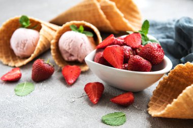 Çilekli dondurma ve waffle koni taş zemin üzerine