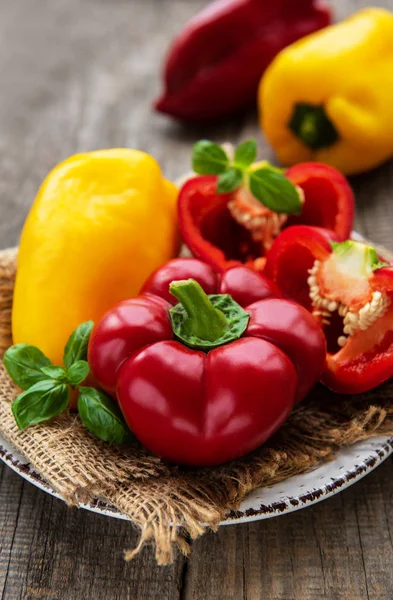 Plate with Bell peppers on a wooden background