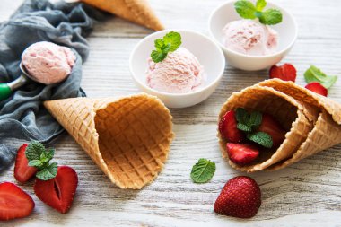Çilekli dondurma ve waffle koni ahşap arka plan üzerinde