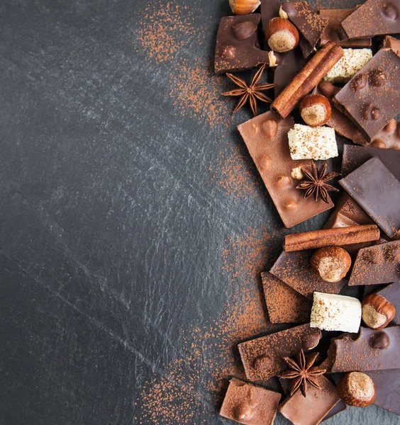 Chocolate with nuts on a black stone background