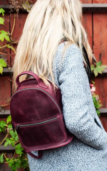 beautiful caucasian girl with a leather backpack