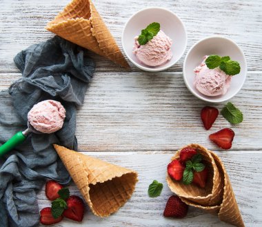 Çilekli dondurma ve waffle koni ahşap arka plan üzerinde