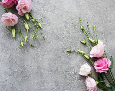 Beton zemin üzerine taze pembe eustoma çiçekli çerçeve