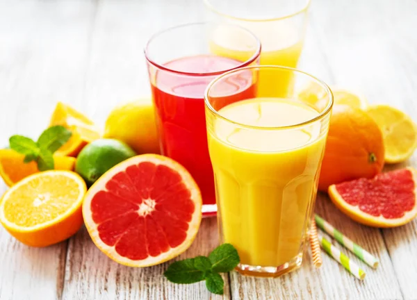Glasögon Juice Och Citrusfrukter Ett Träbord — Stockfoto