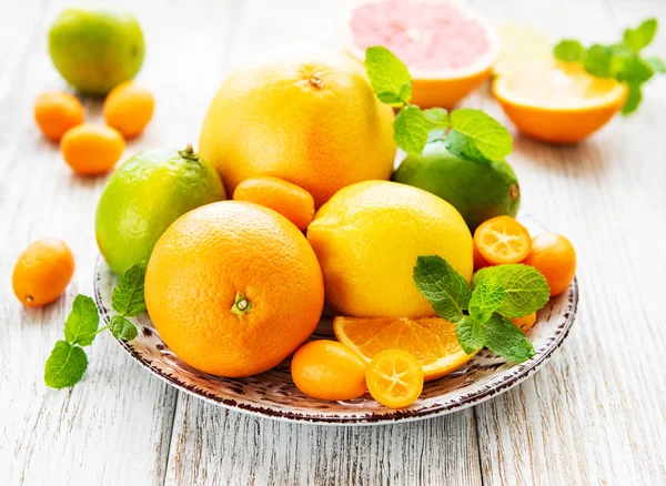 Fresh citrus fruits on a old wooden background