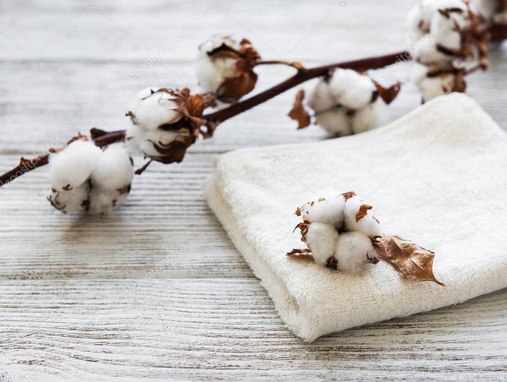 cotton flower and towel on a old wooden table