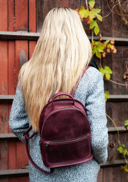 beautiful caucasian girl with a leather backpack