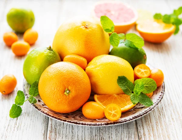 Fresh citrus fruits on a old wooden background
