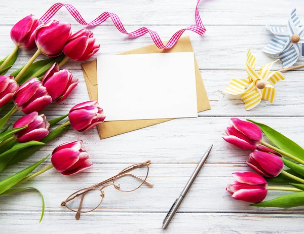 Pink spring tulips and greeting card — Stock Photo, Image