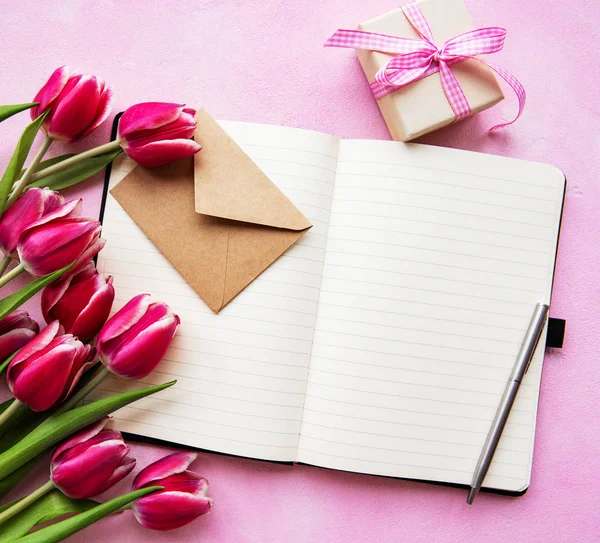 Notebook, gift box and pink tulips — Stock Photo, Image