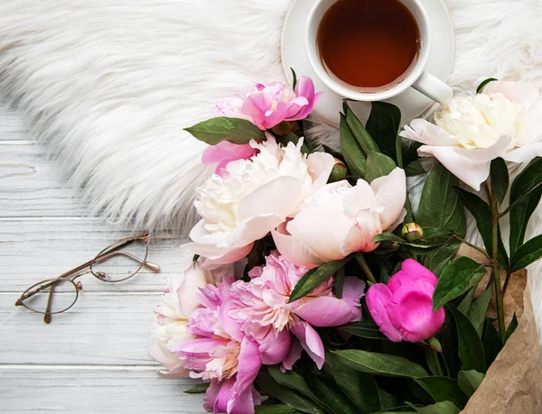 Kopp med te og rosa peoner – stockfoto