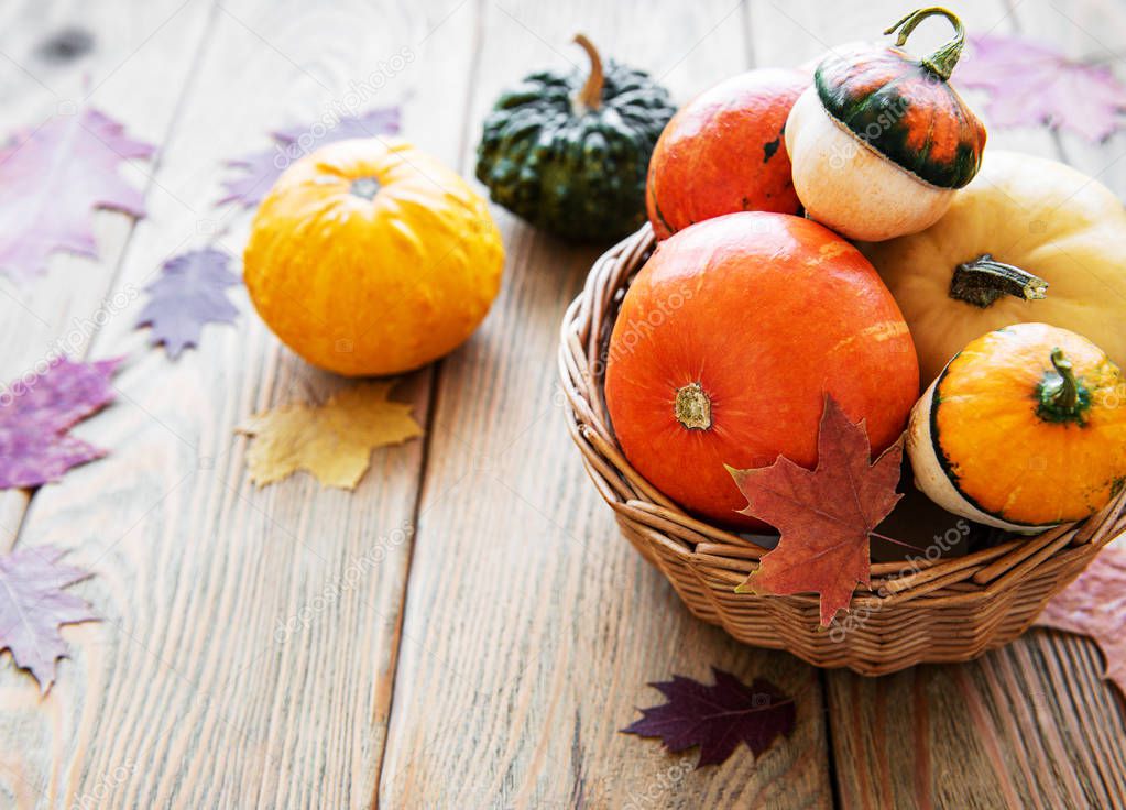 Basket with Pumpkins on a wooden table