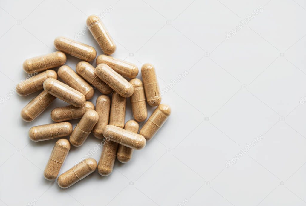 Herb capsules, Nutritional Supplement, Vitamin Pills, Herbal Medicine on white background.